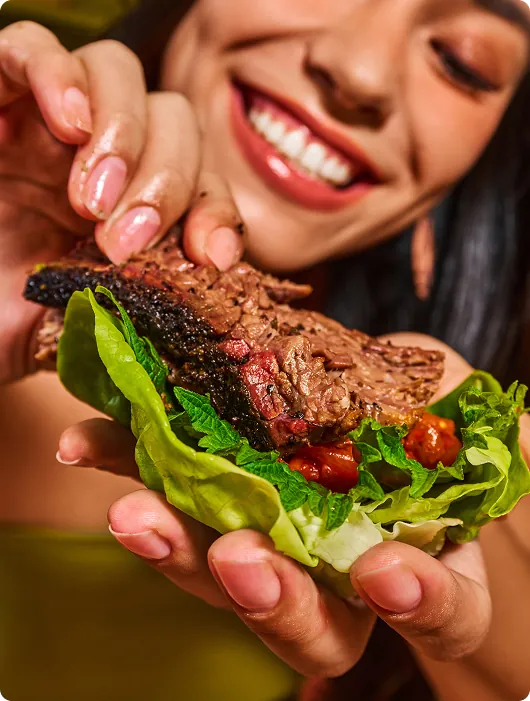 Eating a loaded lettuce wrap